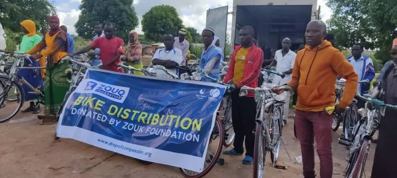 Community members receiving bicycles